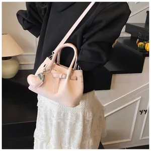 Detailed view of the pink bucket handbag with heart pendant, stylish casual crossbody design.