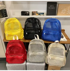 Detail view of colorful mesh beach backpacks displayed in a cozy lifestyle setting.