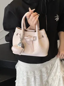 Pink textured bucket bag for women, stylish niche design handbag with heart charm for daily.