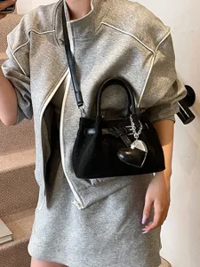 Stylish black woven shoulder bag for women, trendy crossbody handbag with heart charm summer.