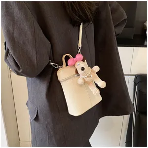 Korean style chic beige cylindrical crossbody mini bag with cute plush dog pendant detail.
