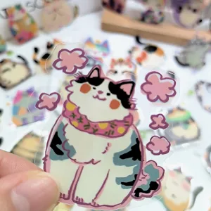 Detailed close-up of a transparent PET cute fat cat sticker, waterproof laptop decor item.
