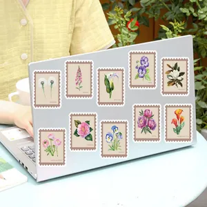 Detail view of vintage botanical floral stickers applied on a laptop surface, waterproof decorative decal.