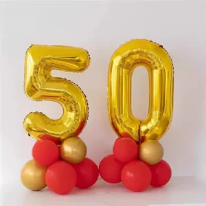 Gold number 50 foil balloons with red latex balloon bases for birthday party decorations details.