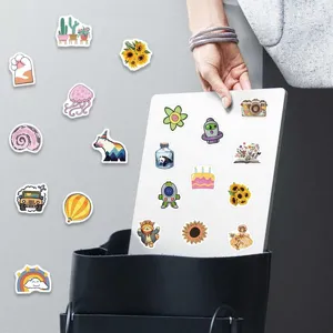Close up detail of assorted cute cartoon VSCO aesthetic stickers for laptop phone decor.