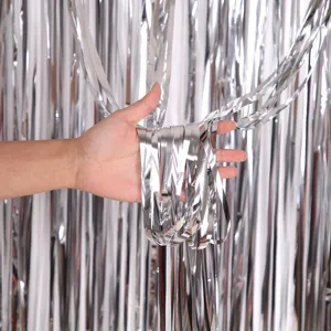 Silver foil fringe curtain detail shot, shining tinsel backdrop for party celebration.
