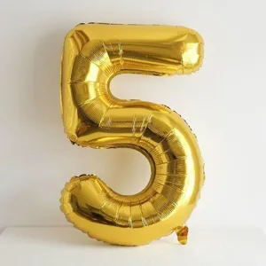 Close up of gold number 5 foil balloon, ideal for birthday party scene decoration details.