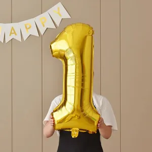 Gold number 1 foil balloon photo prop for kids 1st birthday party decoration and celebration layout.
