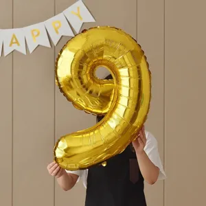 Gold number 9 foil balloon for birthday party decorations, shiny metallic finish photography props.