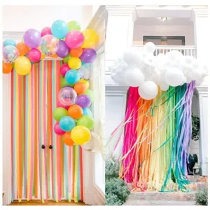 Colorful crepe paper streamers party backdrop scene detail, ideal for festive wall decoration setup.