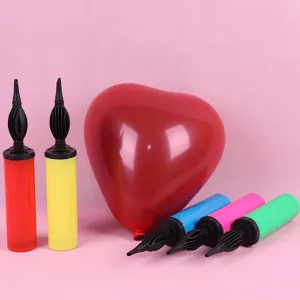 Portable manual balloon pump for latex and foil balloons, ideal for party decoration setup.