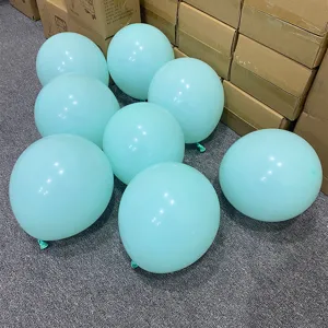 Close-up detail of light blue latex balloons arranged on floor for party decoration scene.