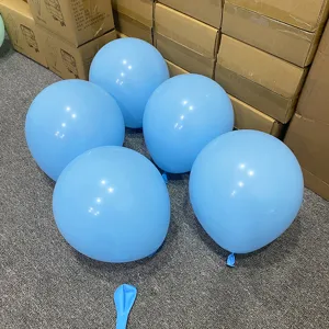 Detailed shot of light blue latex balloons in warehouse scene, ideal for party decoration setup.