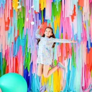 Colorful crepe paper fringe backdrop for party decorations and vibrant wall photo shoots.
