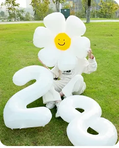 Large white number foil balloons and giant daisy flower balloon for birthday party decor