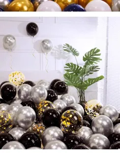 Detailed view of luxury metallic silver, black and gold confetti party balloons for wedding.