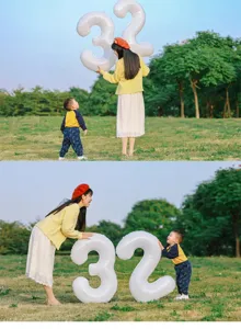 White number 32 foil balloon detail showing size and shape for party decoration setup.