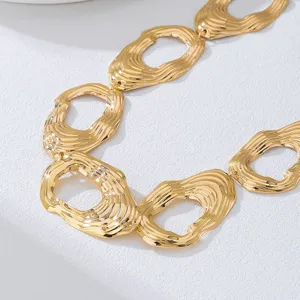Close-up detail of stylish gold metallic textured circular link chain belt fashion accessory.