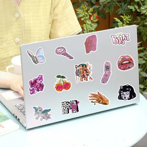 Detailed view of trendy Y2K aesthetic vaporwave DIY stickers applied on laptop surface.