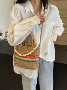 Woven straw bucket bag for women with pearl chain and rainbow stripe design, stylish crossbody.