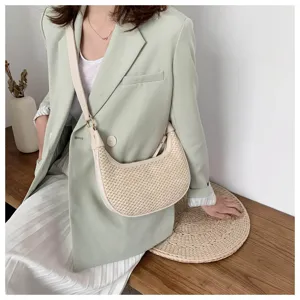 Detailed view of women straw woven shoulder bag, chic underarm handbag for summer season.