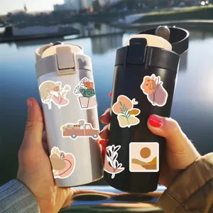 Boho aesthetic waterproof vinyl sticker scenic display on insulated water bottles.