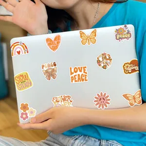 Detailed view of cute aesthetic retro boho waterproof vinyl stickers featuring positive quotes on laptop.