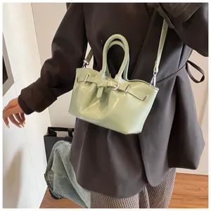 Light green oil wax leather pleated mini crossbody bag with chic buckle and top handle details.