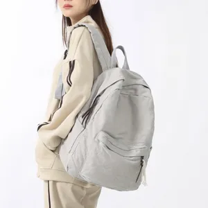 Sac à dos en toile décontracté minimaliste pour femme, cartable uni pour voyage quotidien.