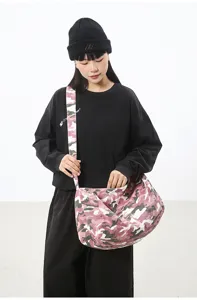 Close-up detail of the pink camo canvas bag shows slouchy design and large capacity.