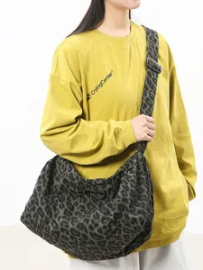 Stylish canvas crossbody shoulder bag for women, large capacity casual daily bag.
