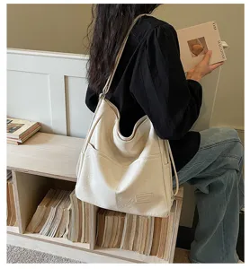 Large capacity soft leather shoulder bag for women, casual commuting crossbody tote style.