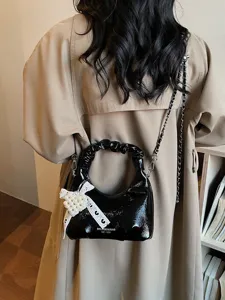 Trendy Japanese Korean style black glossy ruched handbag with chain strap and pearl bow charm for women.