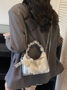 Stylish metallic silver hobo cloud bag with ruffled handle, chain strap, and pearl heart charm for women.