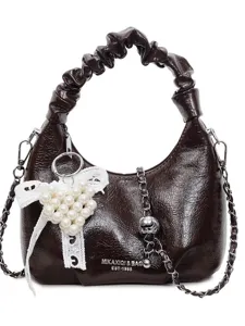 Dark brown shiny ruched shoulder bag with pearl heart charm and stylish chain strap.