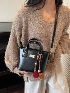 Chic black patent leather bucket bag for women, versatile stylish crossbody handbag for daily wear.