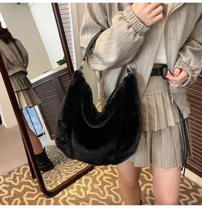 Detailed view of black fluffy shoulder bag, soft faux fur texture for autumn and winter.