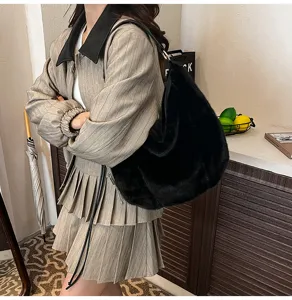 Detailed view of women's black fluffy shoulder bag, soft plush hobo bag for autumn and winter.