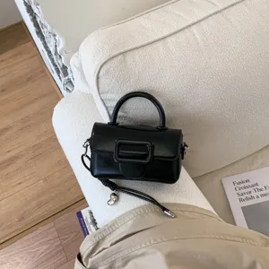 Chic black mini crossbody bag with top handle and stylish square buckle for women daily wear.
