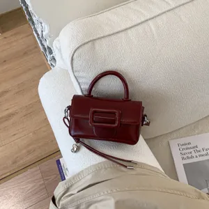 Chic wine red small square crossbody bag for women, trendy leather fashion shoulder handbag.