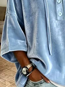 Close-up view of the light blue velvet short-sleeve top showing soft fabric texture.