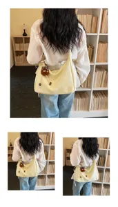 Minimalist large capacity shoulder bag for women, stylish hobo tote bag with cute plush pendant.
