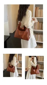 Detailed lifestyle view of a soft leather shoulder bag worn by a model in a cozy library setting.