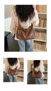 Large capacity brown shoulder bag women fashion versatile slouchy hobo tote with cute pendant.