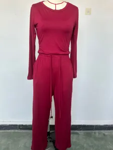 Burgundy long sleeve top and wide leg pants detail view of casual solid color sportswear set.