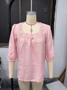 Pink square neck lace trim 3/4 sleeve blouse detail view showing textured fabric and collar.