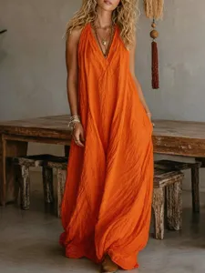 Vestido largo maxi holgado sin mangas en algodón naranja brillante con bolsillos laterales.