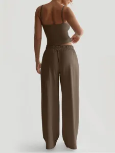 Women's brown spaghetti strap crop top and wide leg lounge pants set detail view.