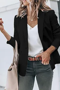 Detail view of women's black long sleeve blazer jacket worn in casual street style.