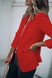 Detail shot of women's long sleeve solid color blazer suit jacket in red for autumn fashion.